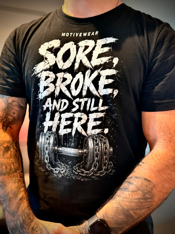 MOTIVEWEAR® Men's "Sore, Broke, Still Here" Premium Tee